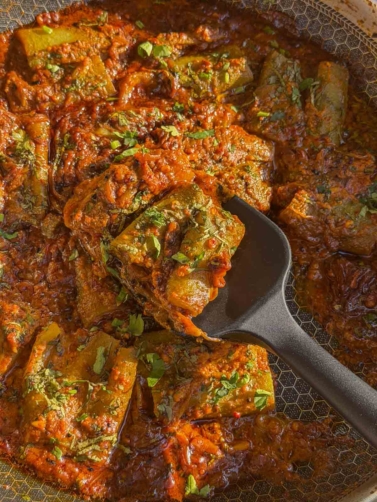 a close up image of stuffed turai ki sabzi to showcase it's color and texture