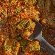 a close up image of stuffed turai ki sabzi to showcase it's color and texture