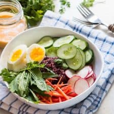The Black Rice Salad Bowl with Spicy Peanut Dressing served in a white bowl.