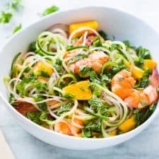 Cucumber Noodle Prawn and Mango Salad served in a white bowl.
