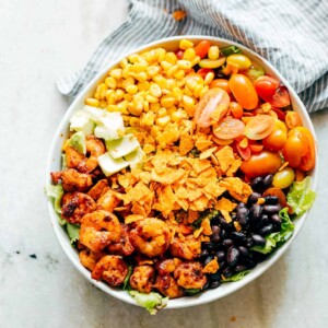 Ingredients of the salad assembled together in a white bowl.