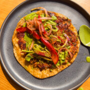chicken smash taco served on a black plate