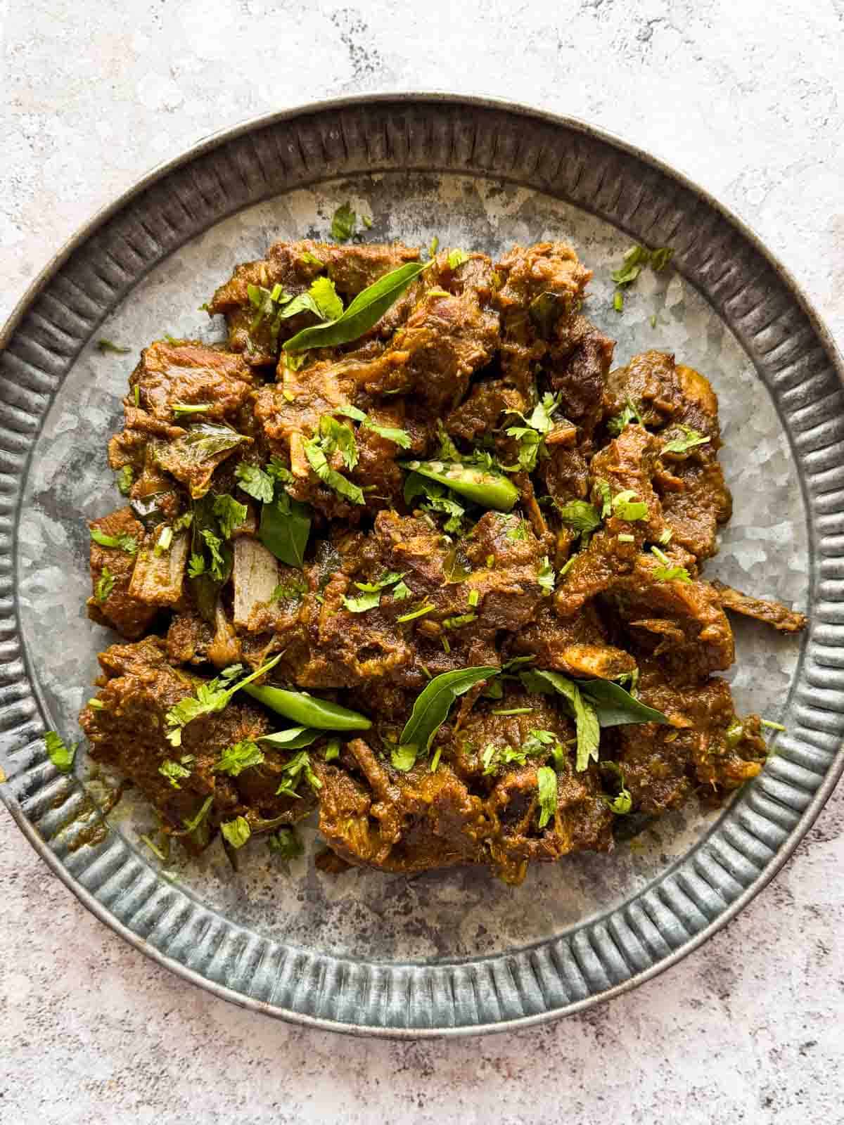 a plate with pepper mutton fry in it