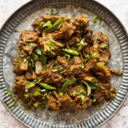 a plate with pepper mutton fry in it