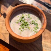 an earthen bowl with ragi ambli in it