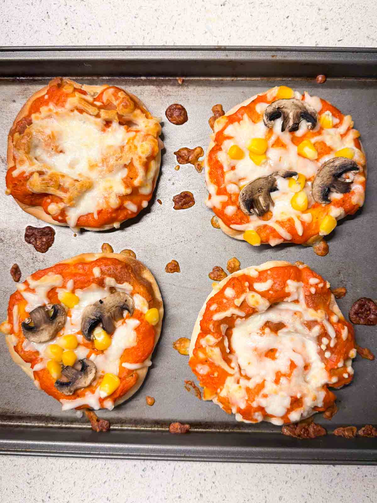 gour mini veg pizzas on an oven tray