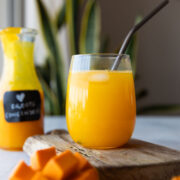 mango juice in a glass jar with straw