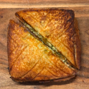 thecha paneer sandwich cut in half and ready to be served