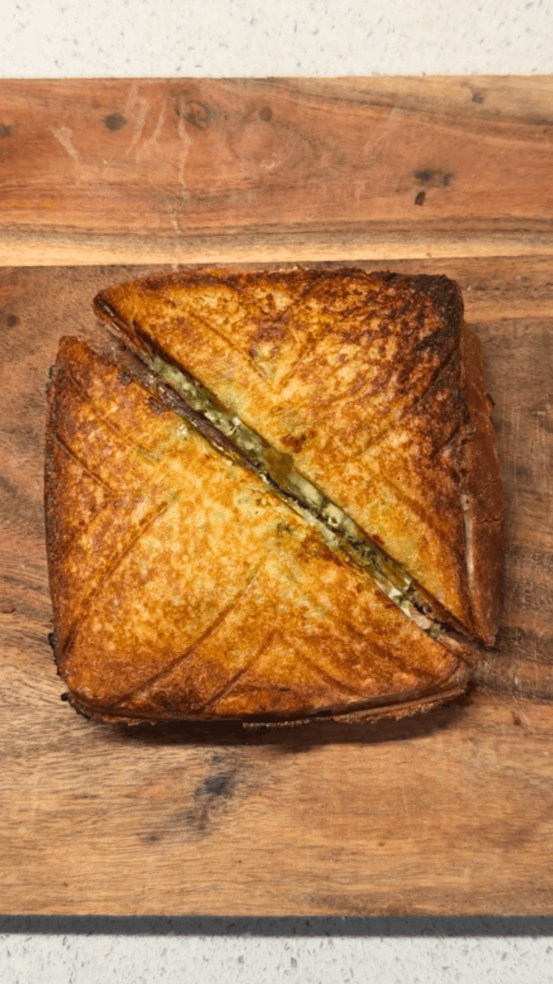 thecha paneer sandwich cut in half and ready to be served