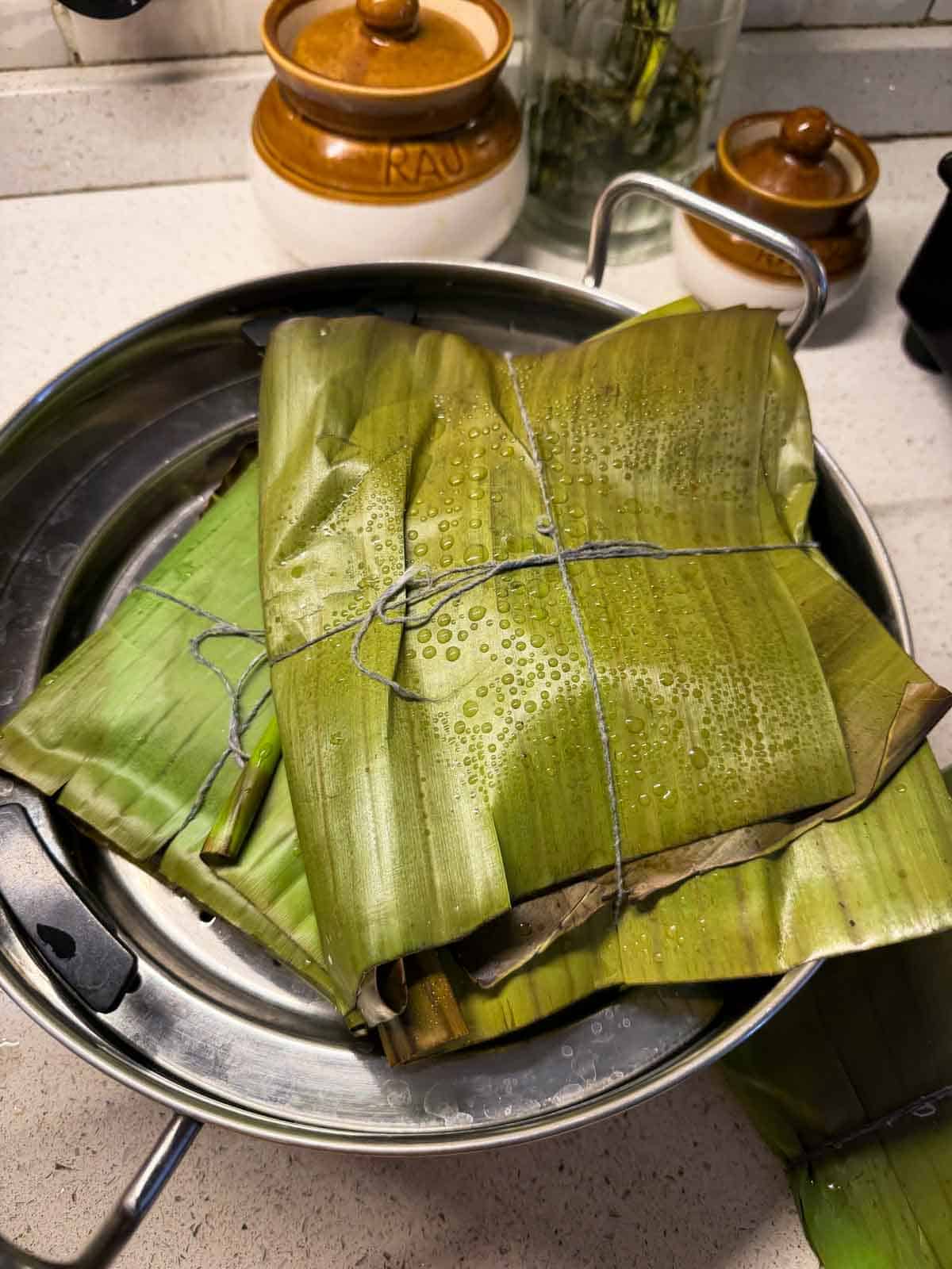freshly steamed veg potli biryani ready in the banana leaf wrapping