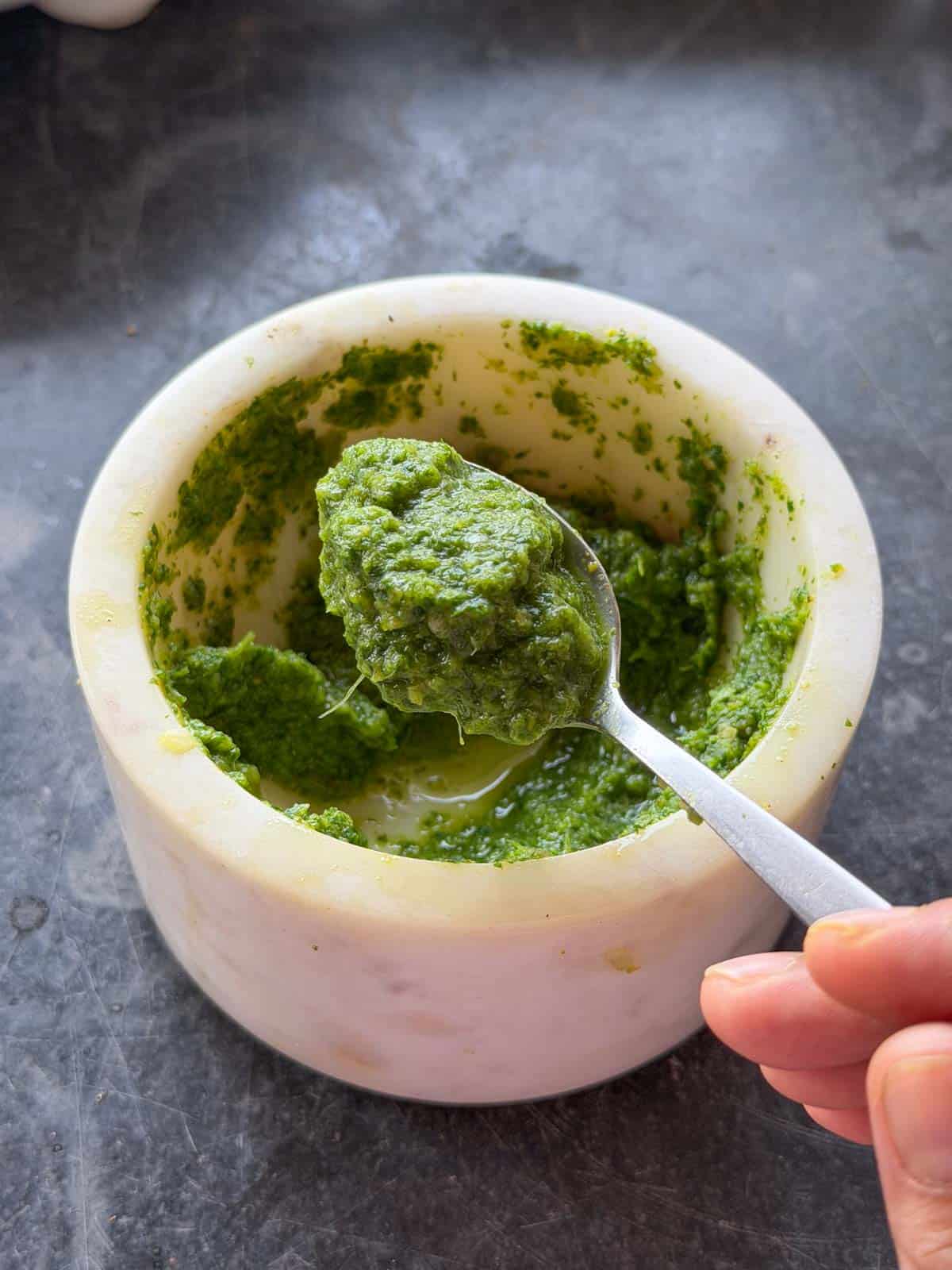 the green chutney for masala stuffed egg spooned up to showcase color and texture