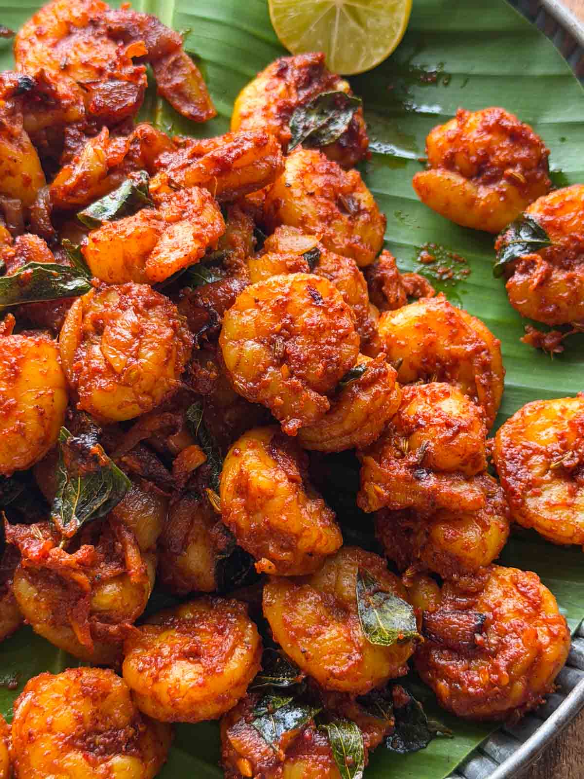 kerala prawn roast served over a banana leaf