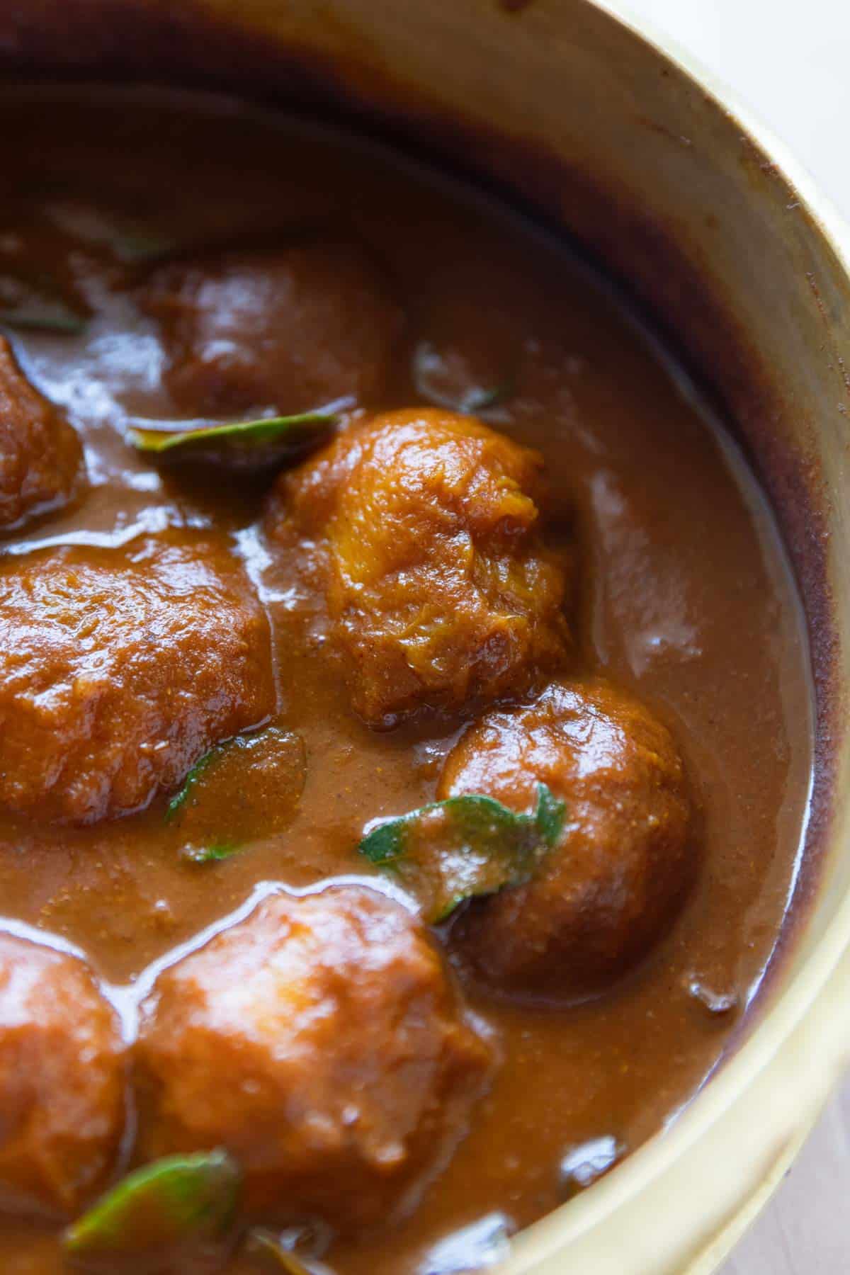 a close up image of Mango Curry pictured in the copper pot that it was cooked in
