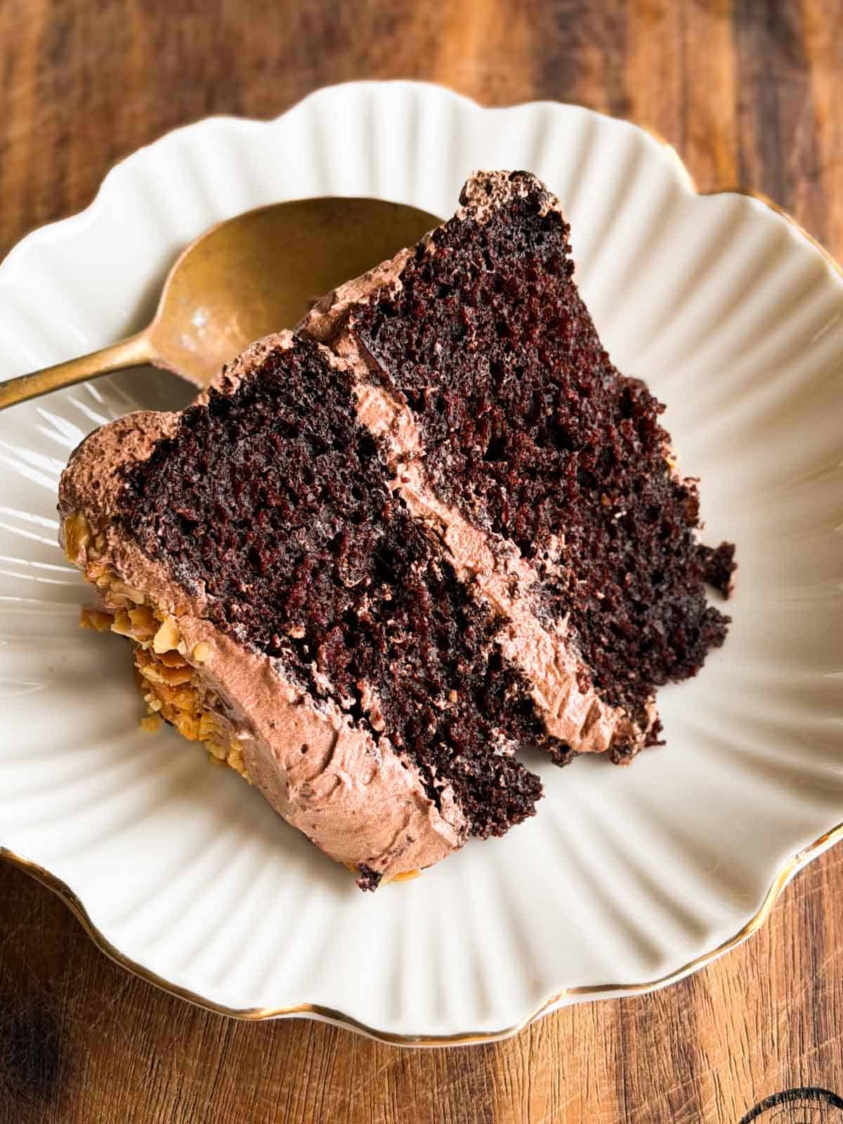 a slice of the one bowl chocolate cake served on a white dish with a spoon