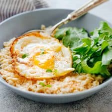 Savory Garlic Oats with served with Masala Fried Egg and basil- a lip-smacking breakfast.