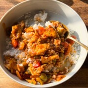 Spicy chilli egg stir fry served over white rice in a bowl.