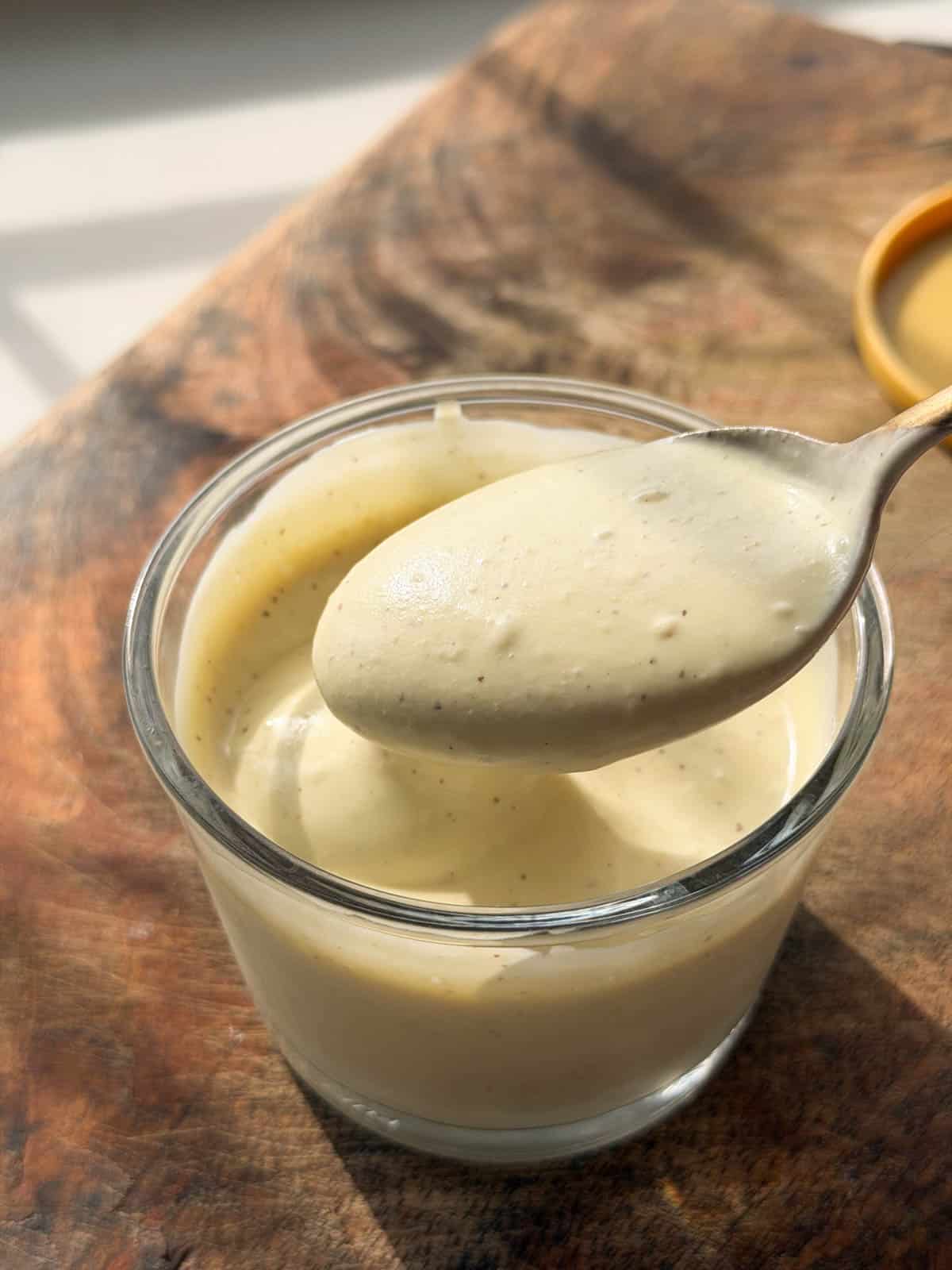 smooth and creamy veg mayo scooped up in a spoon