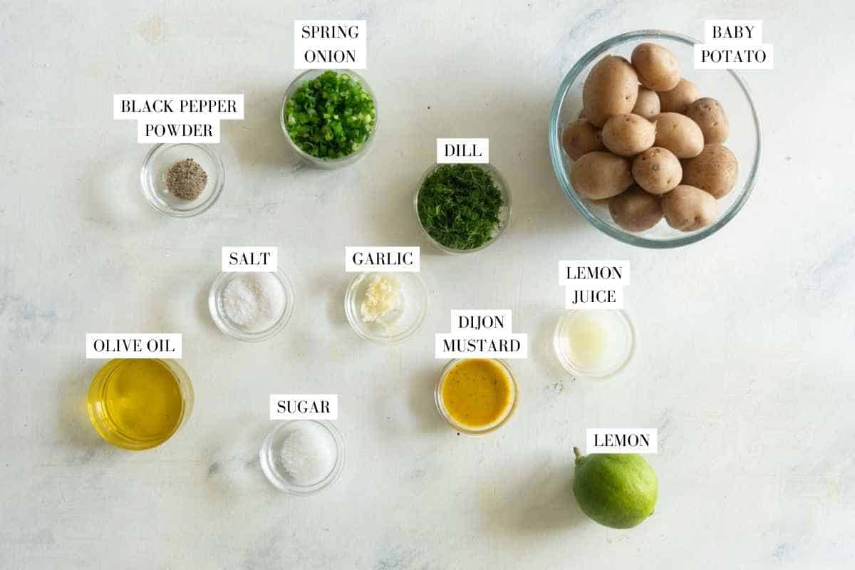 Picture of all the ingredients for healthy lemony potato dill saladwith text to identify them