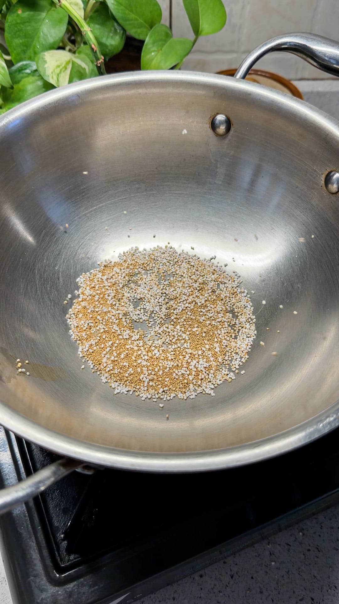 a small batch amaranth seeds in a kadai about to pop
